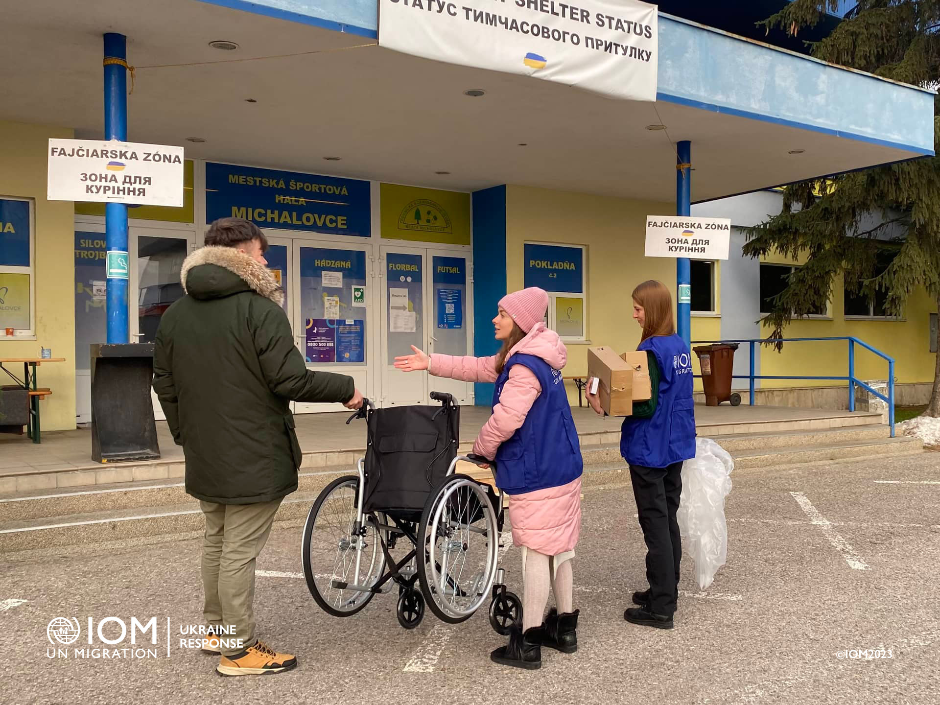 IOM frontline team transfers a wheel chair in Michalovce Registration Centre. Photo © International Organization for Migration (IOM) 2022.